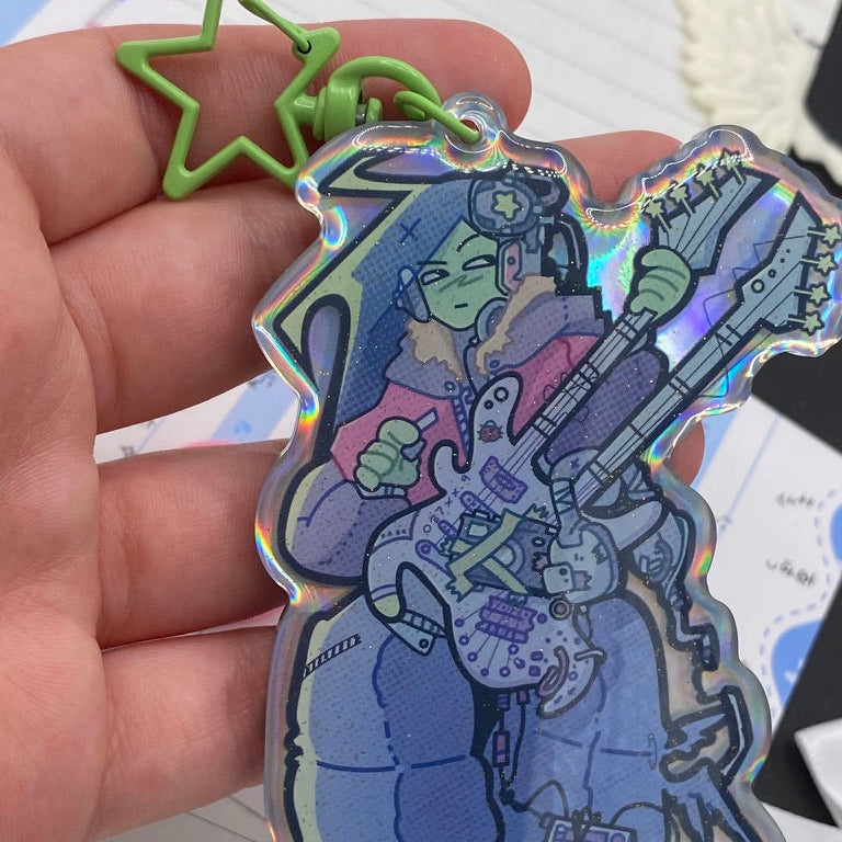 Alien girl holo backing keychain in hand