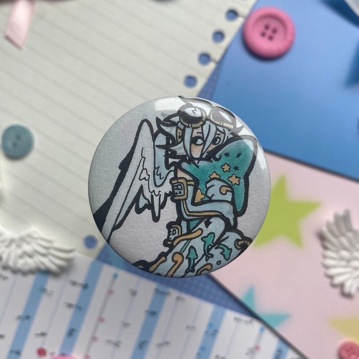 Angel holding shark button badge pin