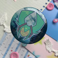 shiny metal round button badge with head shot of anime character with turquoise pig tails