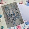 Person with huge flowing wings on matt card