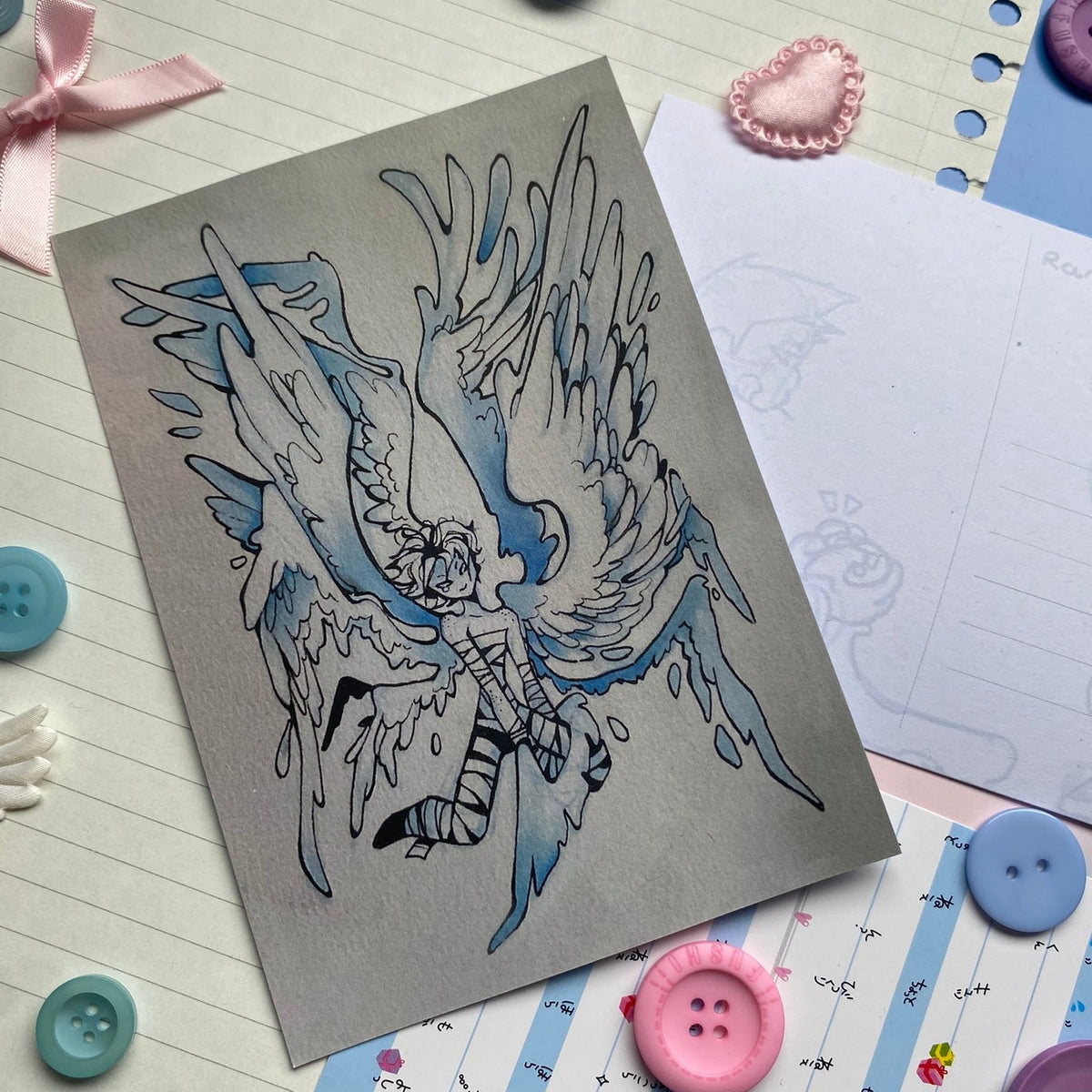 Person with huge flowing wings on matt card