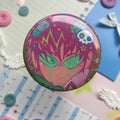Shiny round button badge with image of pink haired character and green glasses