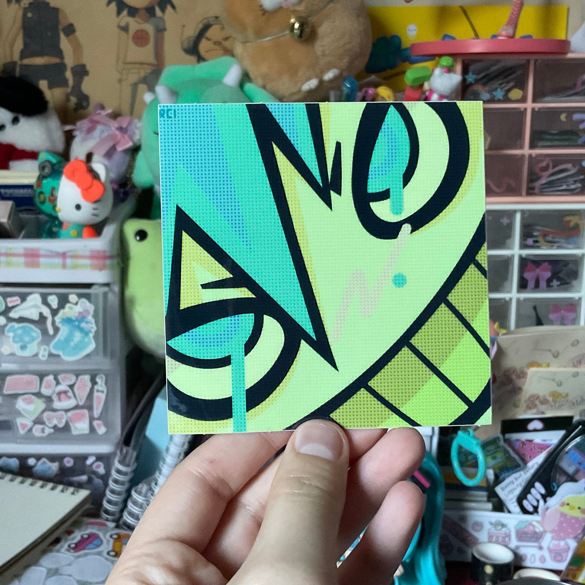 hand holding the green cyber singer square sticker
