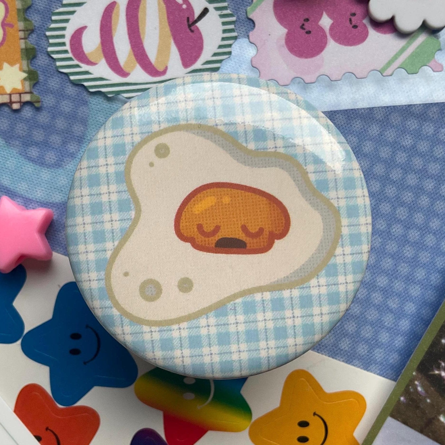 egg dog sleeping face as egg yolk on blue check badge