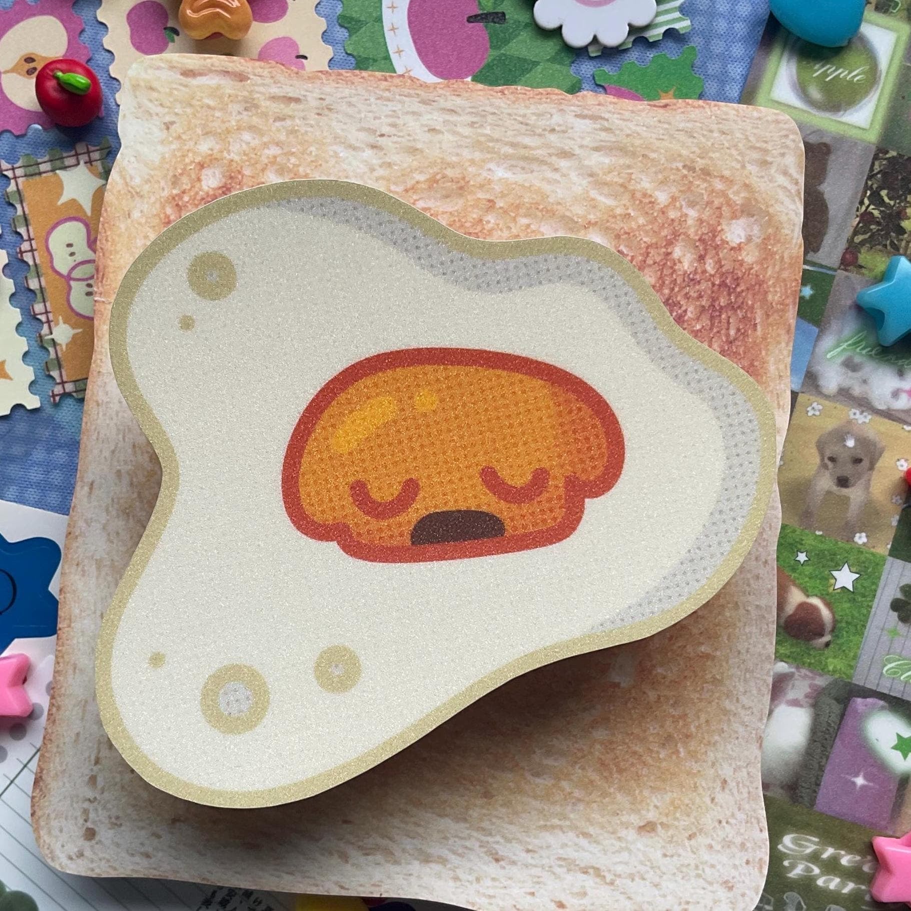 Fried egg shaped sticker with yellow yolk shaped like sleeping dog head