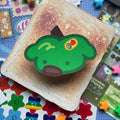 Green apple sticker in the shape of a dog with a dog face and a fruit label on the top.