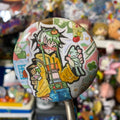 shiny round button badge with character with green hair and many trinkets on their bag