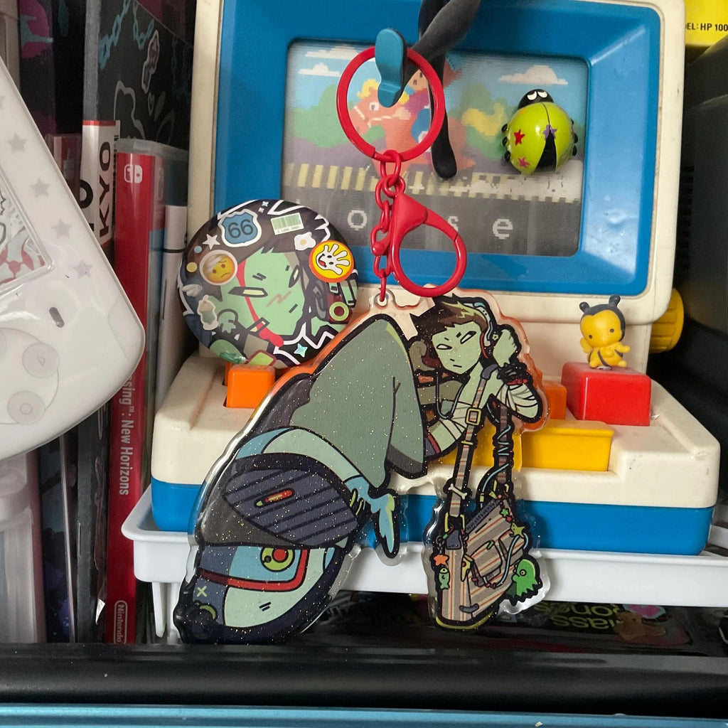 Large Lidia epoxy keychain in front of vintage toy computer backdrop