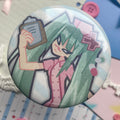 large shiny round button badge with turquoise pony tailed nurse character