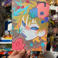 Toast muncher print with orange creature and yellow hair on matt a5 print