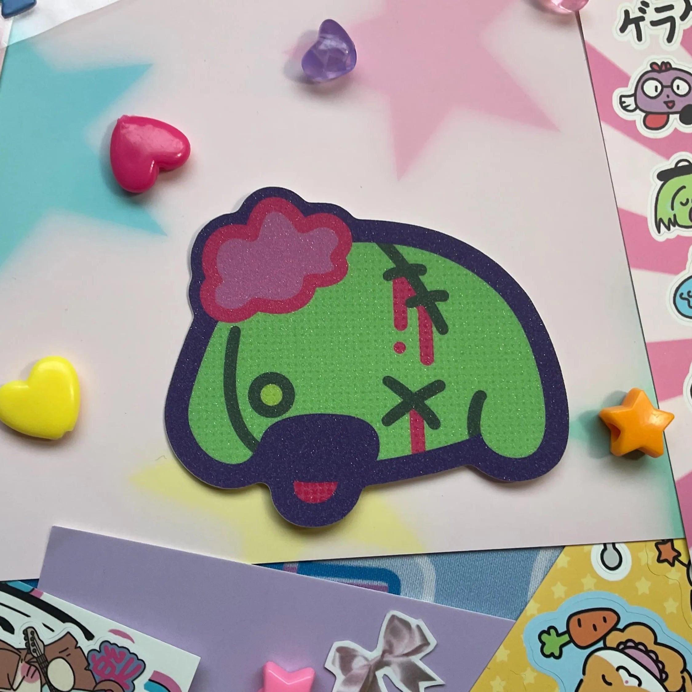 Zombie dog sticker in dog head shape, green with pink puff on head